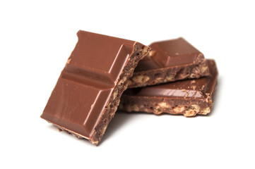 closeup of milk puffed rice chocolate blocks on white background