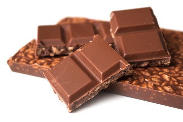 closeup of milk puffed rice chocolate blocks on white background