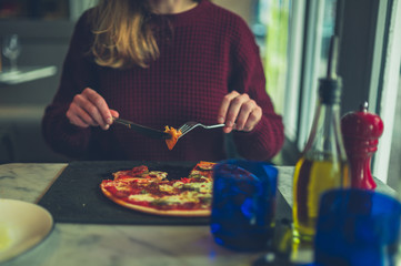 Young woman eating pizza