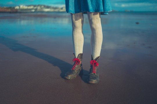 Legs and feet of young woman on the beach in winter