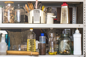 mess in the kitchen on the shelf for kitchen utensils
