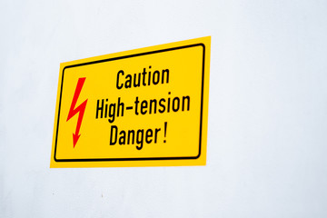 Danger High Voltage Sign for risk on yellow background.