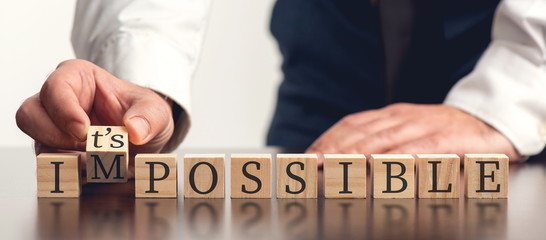 Impossible Concept With Businessman and  Wooden Blocks