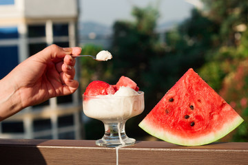 vanilla ice cream served with watermelon slices, cold summer dessert on the terrace