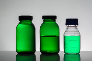 Liquid in laboratory bottles. Scientific biochemical laboratory. Colorful liquid.