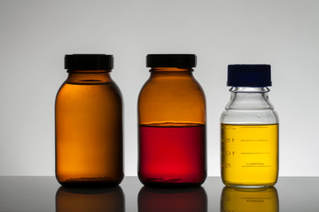 Liquid in laboratory bottles. Scientific biochemical laboratory. Colorful liquid.