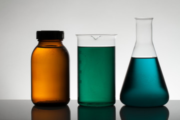 Liquid in laboratory bottles. Scientific biochemical laboratory. Colorful liquid.