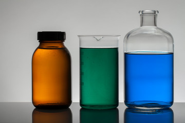 Liquid in laboratory bottles. Scientific biochemical laboratory. Colorful liquid.