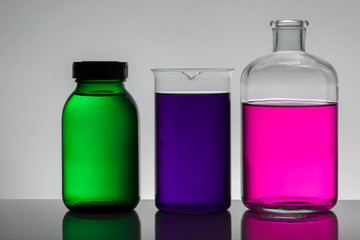 Liquid in laboratory bottles. Scientific biochemical laboratory. Colorful liquid.