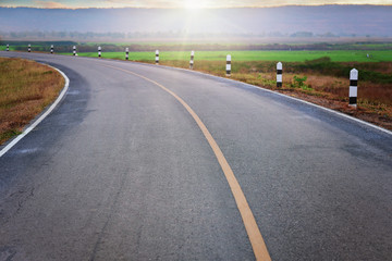 landscape scene and sunrise above road