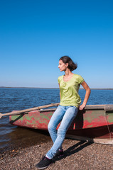 Girl near the boat on the bank of the Amur River, below the village of Sikachi-Alyan