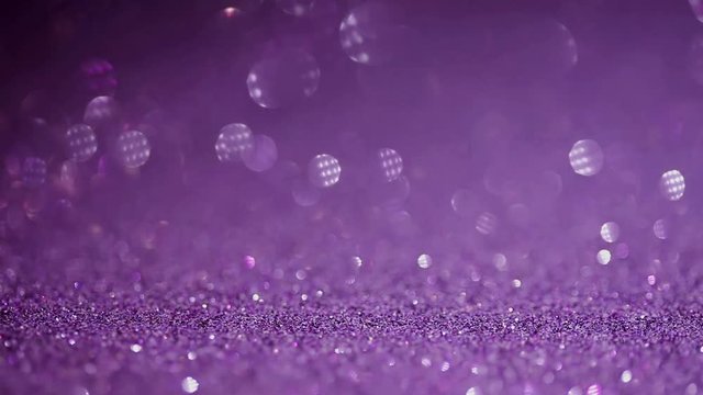 Purple glitter magic background. Defocused light and free focused place for your design.