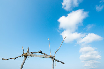 Decorative wooden arced against blue sky.