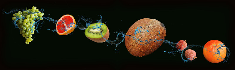 fruits - grapefruit, grapes, lychee, kiwi, coconut on an isolated black and green background