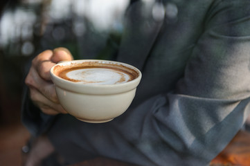 Business man drinking coffee,Man taste coffee ,A cup of coffee in hand,Selective focus