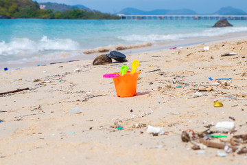 Dirty beaches.Caused by the dumping of undisciplined. Pollution on the beach of tropical sea. Environmental pollution. Children's toys on the dirt beach.