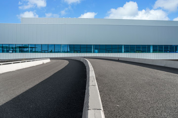 Road asphalt pavement and modern factory warehouse..