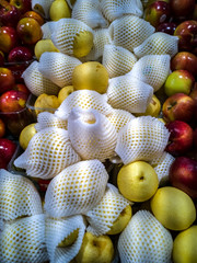 Pile of a new hybrid sort of pear and apple on Mediterranean market