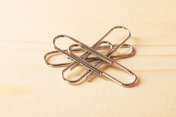 close up of paper clip on wooden