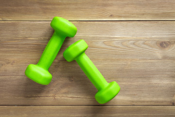 dumbbells on wooden background