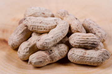 Peanut in a shell on a wooden background