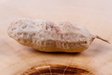 Peanut in a shell on a wooden background