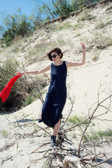  Woman in a dress walks on a log
