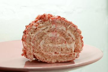 Sweet roll with jam and a knife on a cutting board