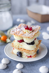 Tea and sweets on a light background, Mille-feuille, Eclairs, Tart, Decorative with flowers, Selective focus, Closeup