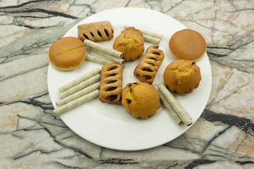 Colorful macarons cake, top view flat lay fly falling sweet macaroon on color white isolated background Minimal concepts falling macaroons pattern above food natural background