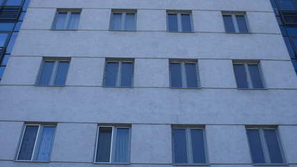 Gray modern building facade with new pvc windows