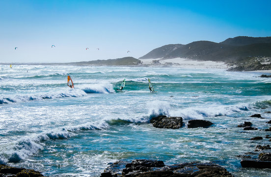 People windsurfing on a beach in the Cape of Good Hope National Park near Cape Town, South Africa