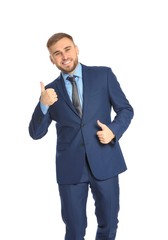 Young businessman celebrating victory on white background