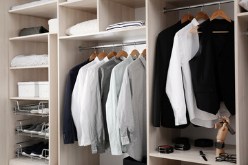 Stylish clothes, shoes and home stuff in large wardrobe closet