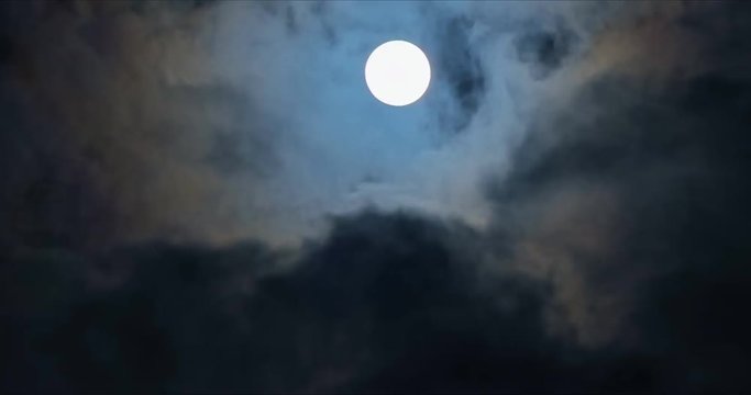 Full moon with fast mooving clouds timelapse at night. 4k 60fps Ultra HD video.