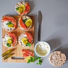 Sandwiches with cottage cheese, red fish, ginger and pickled cucumber on a cereal loaf