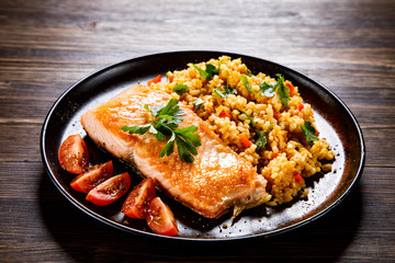 Roast salmon with groats and vegetables