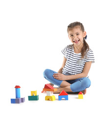 Cute child playing with colorful blocks on white background