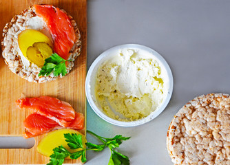 Sandwiches with cottage cheese, red fish, ginger and pickled cucumber on a cereal loaf
