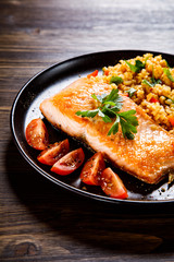 Roast salmon with groats and vegetables