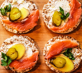 Sandwiches with cottage cheese, red fish, ginger and pickled cucumber on a cereal loaf