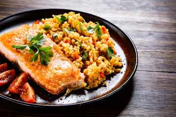 Roast salmon with groats and vegetables