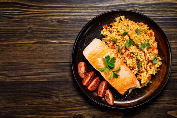 Roast salmon with groats and vegetables