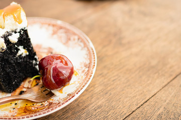 Dark beer chocolate cake (Chocolate Stout Cake) with caramel sauce and juicy fruits on top. Copy space