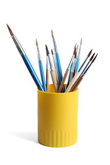 Holder with different paint brushes on white background