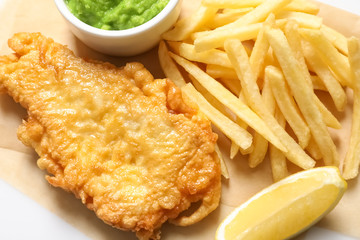 British Traditional Fish and potato chips on table, closeup