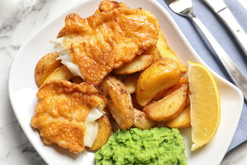 Plate with British traditional fish and potato chips, top view