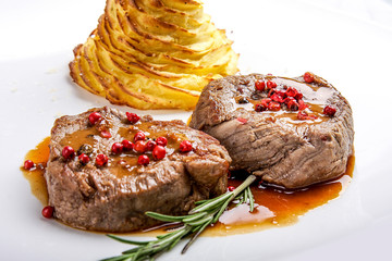 Medallions of veal with rosemary on a white background