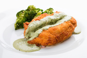 Chicken fillet with avocado sauce on white background