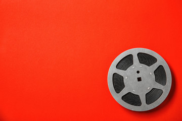 Movie reel on color background, top view with space for text. Cinema production